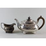 A Georgian silver teapot with rectangular body and wooden handle (marks rubbed), 18oz gross, and a