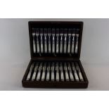 A set of twelve Victorian mother of pearl handled dessert knives and twelve forks with floral and