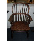 A 19th century stick back Windsor elbow chair with elm seat on turned legs