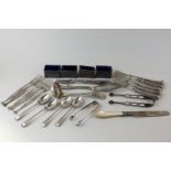 A collection of silver items to include butter knife, sifter ladle, five forks and tongs (sterling),