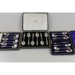 A set of six silver coffee spoons with plated tongs in case, another set of six silver teaspoons