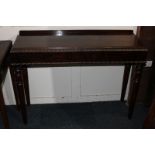 A late Regency narrow rosewood side table with applied beaded edge, on four turned tapered legs,