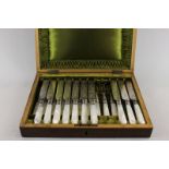 A set of ten Victorian mother of pearl handled dessert knives and ten forks in case