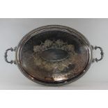 A Victorian silver plated serving tray with two cast foliate handles and engraved decoration, 79cm