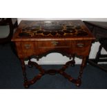 A William and Mary style walnut lowboy with oyster veneered panel top and three drawers with