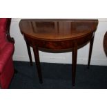 A George III mahogany bowfront card table with folding top on four square legs with block feet,