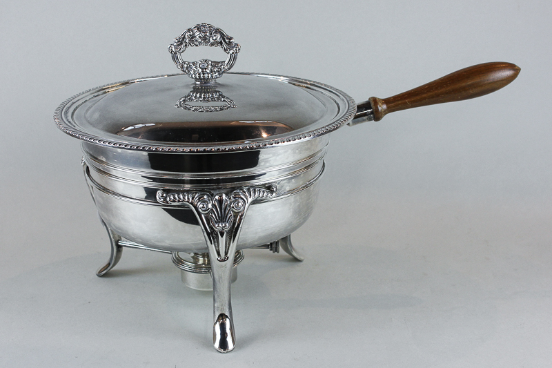 A silver plated chafing dish and cover on stand with spirit burner, with cookbook