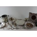 A small circular plated salver and other plated items to include a 19th century wine coaster,