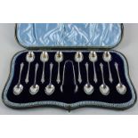 A set of twelve Edwardian silver Apostle handled teaspoons and tongs, maker James Dixon and Sons