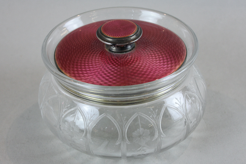 A cut glass and flower decorated clear glass bowl with pink enamelled and silver top