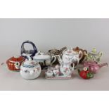 A collection of miniature china and clay teapots and a miniature tea set in both European and