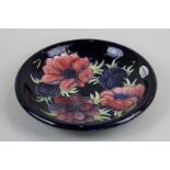 Moorcroft, an anemone decorated shallow bowl impressed Moorcroft Made in England, 22cm diameter