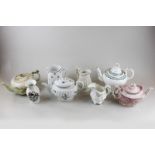 A large assortment of teapots and tea ware in various colours, sizes, and makers (some af)