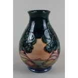 A modern Moorcroft vase, baluster shape, decorated with trees in a pink landscape, 18cm