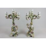 A pair of Continental porcelain candelabra with triple candle branches and cherub figure bases, 33.