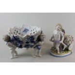 A Sitzendorf German porcelain basket with pierced bowl and three cherub figure base, together with