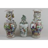 A pair of Chinese porcelain Cantonese style vases decorated in bright colours with figure panels and