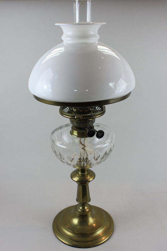 A Victorian brass and glass oil table lamp with facet cut bowl, on circular base, and white glass