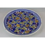 A Delft charger with polychrome floral decoration, 32cm