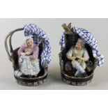 A pair of continental porcelain ornaments, lady and man in half barrel seats (cobbler and his wife),