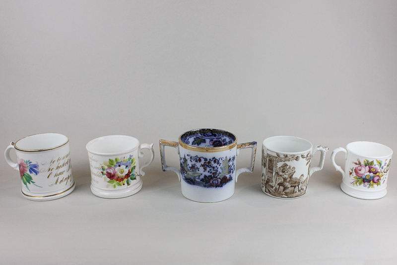 Four 19th century and later porcelain mugs, two with verse and flower decoration, and a two handle