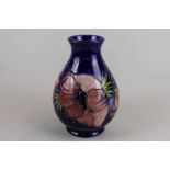 Moorcroft, an anemone decorated vase with monogram and stamped Moorcroft, 20cm high