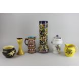 A French 'Tabac' ceramic pot and cover, a Victorian Majolica jug with inscription, a tall