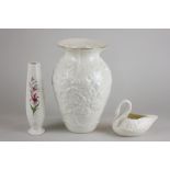 Three Belleek vases, one decorated with a lily, a swan and a Millennium vase (a/f)