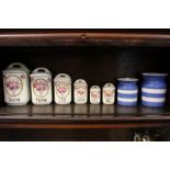 A set of six French pottery kitchen storage pots and covers and two Cornish ware blue and white