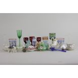 A collection of miniature glass and porcelain cups and saucers, glasses, vases, etc