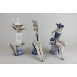 Three Lladro figures of dancers, one dressed as a mouse, another a rabbit and the other as a cat,