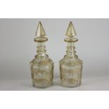 A pair of early 19th century mallet shaped decanters, facet cut triple ring neck, gilt band and swag