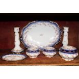 A seven piece Limoges dressing table set comprising oval tray, pair of candlesticks, small pin