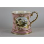 A large Staffordshire mug in pink glaze with gilt oval panel decorated with a church and