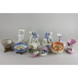 Two porcelain small dishes in the shape of a lady's shoe, a pair  of cherub candlesticks, a