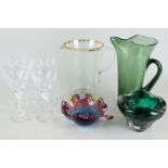 A collection of coloured glass tableware including molar vase, bubble glass jar, goblets, etc