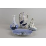 A Royal Copenhagen porcelain oval dish, a small vase, a mermaid on a rock and another vase (a/f),