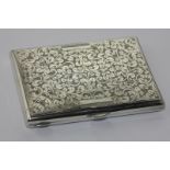 A silver note case, leafy scroll engraved, in fitted case, Birmingham 1897