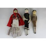 Three 19th century wooden peg dolls with painted heads, one wearing a red cape and costume,