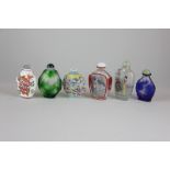 Four Japanese glass snuff bottles, together with two ceramic snuff bottles (one without stopper),