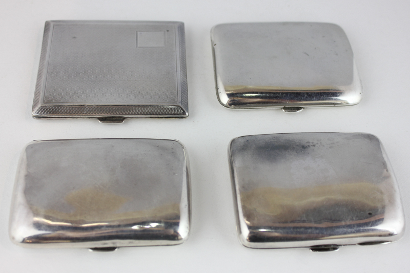 A George V silver cigarette case, Mappin and Webb 1915 Birmingham, together with three other