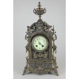 A mid 19th century metal cased French style mantel clock by Gustav Becker, heavily ornamented case