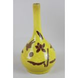 A Japanese bottleneck vase with raised naturalistic decoration on yellow glaze, 20cm high