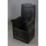 A 17th century oak wainscot chair with locker seat and panelled base (a/f) (NC)