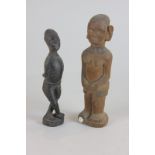 An African hardwood figure of a man with crossed arms and legs, 17cm high, together with a