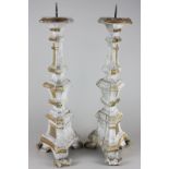 A pair of giltwood and gesso pricket candlesticks, baluster shape on three scroll feet, 49cm
