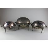 Three silver plated revolving breakfast dishes, one with inner dish and liner, one crested, the