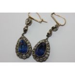 A pair of late 19th century sapphire and diamond drop earrings, the pear shaped sapphires rubover