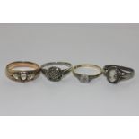 An illusion set diamond ring and three various rings