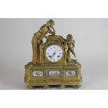 A French gilt metal mantel clock, the eight day movement stamped Paris, the white circular dial with